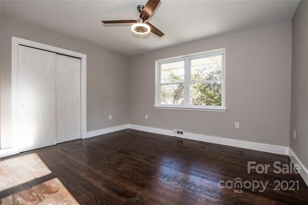 3748 Woodleaf Road Salisbury, NC 28147 - Photo 10 of 31 a view of an empty room with wooden floor and a window