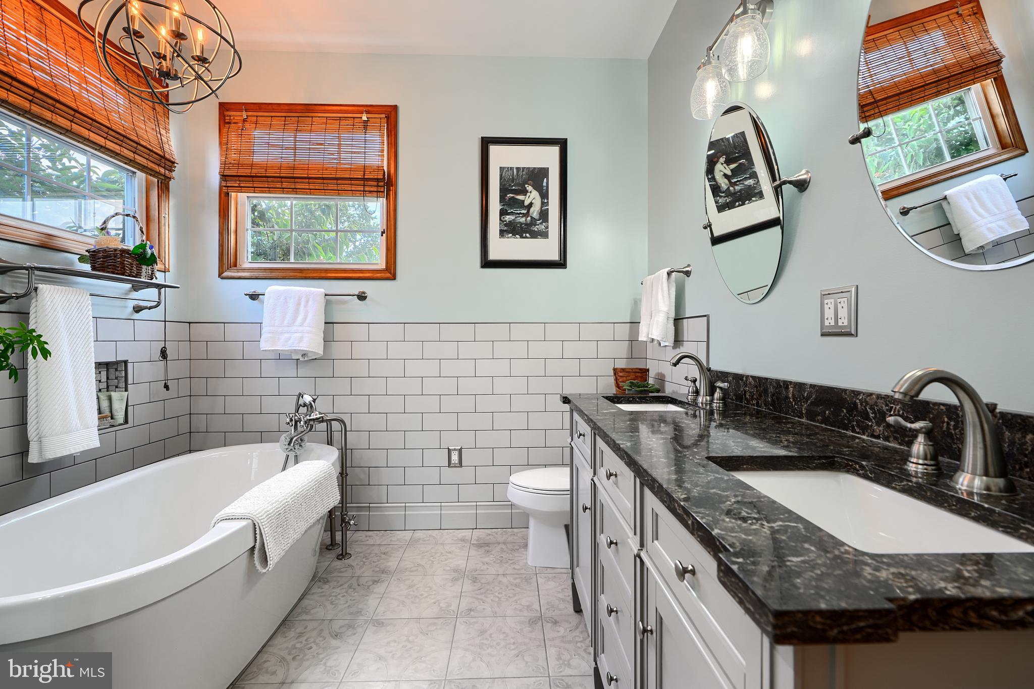 522 Little New York Road Rising Sun, MD 21911 - Photo 37 of 72 a bathroom with a granite countertop double vanity sink a mirror and a bathtub