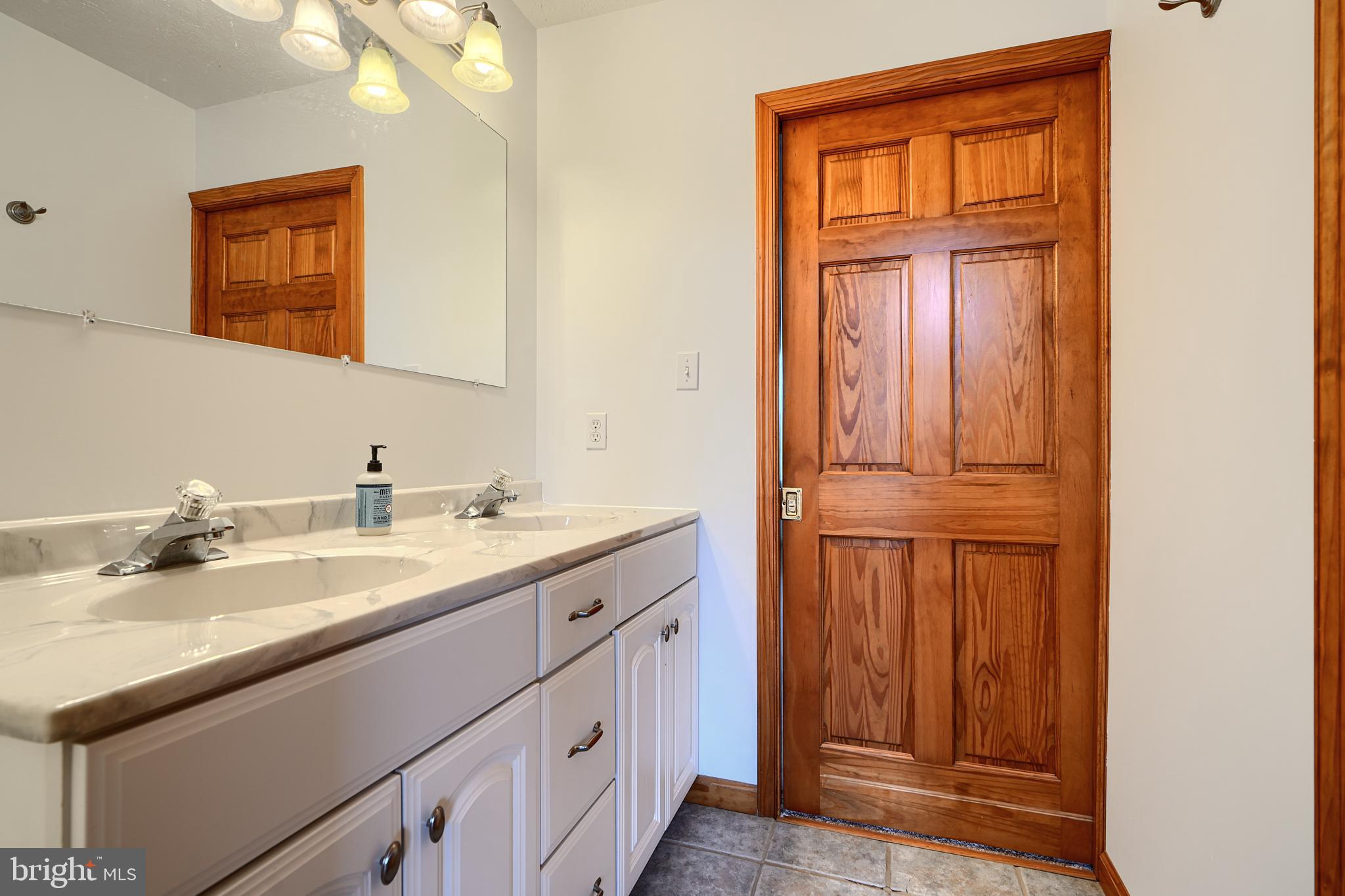 522 Little New York Road Rising Sun, MD 21911 - Photo 54 of 72 a bathroom with a granite countertop sink and a mirror