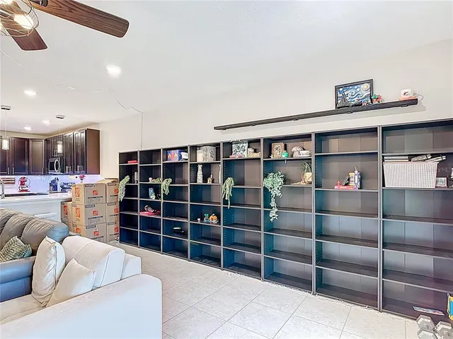 a living room with furniture and a book shelf