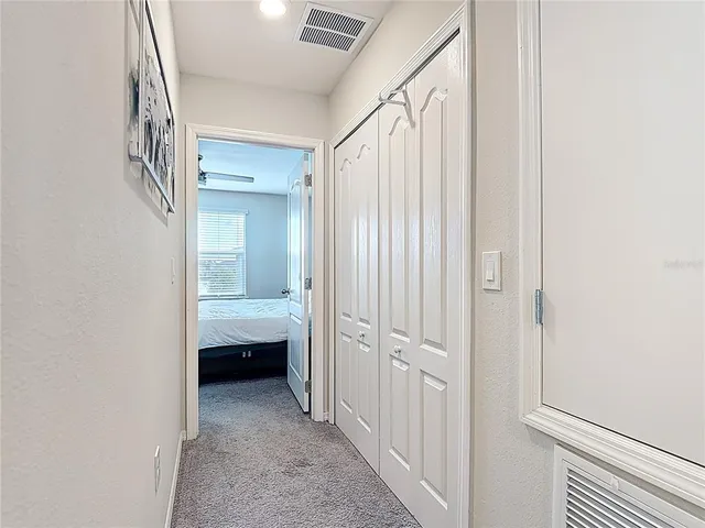 a bedroom with a bed and lamp