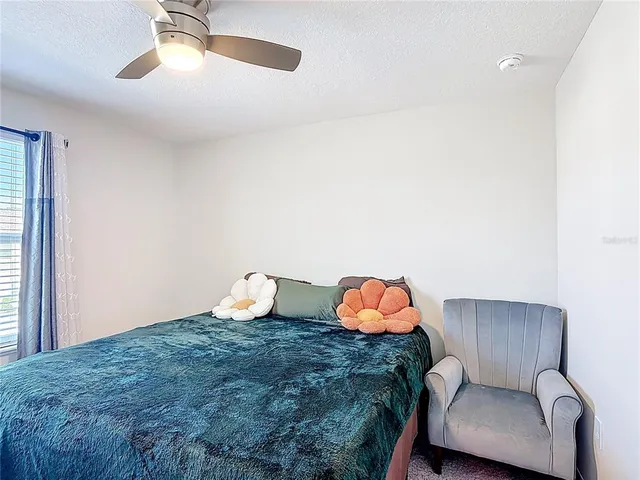 a bedroom with a bed and a desk