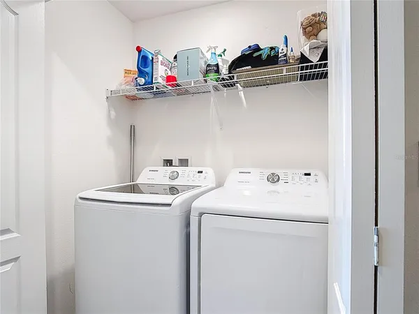 a large bed sitting in a bedroom next to a window