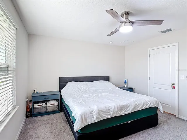 a room with a bed and a flat screen tv