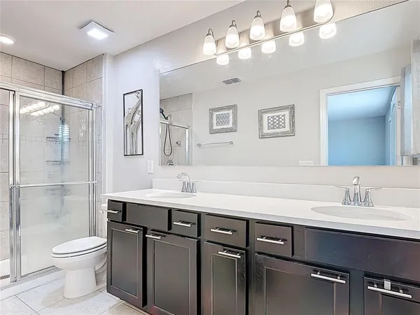 a bathroom with a glass shower door