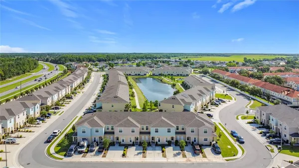 an aerial view of multiple houses with a yard