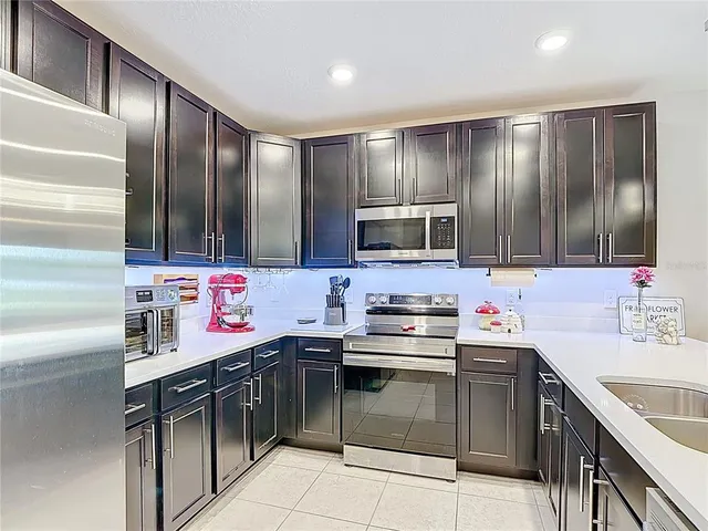 a kitchen with stainless steel appliances a sink stove and refrigerator