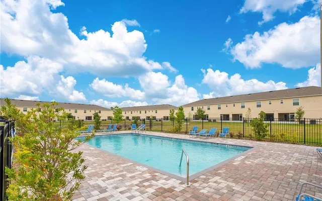 a view of a white house in front of a yard