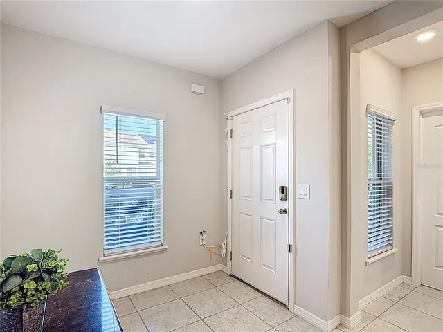 a view of an empty room with a window and a fireplace