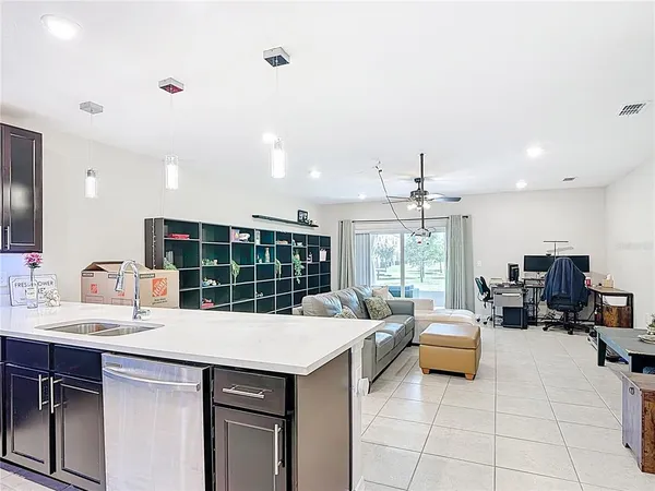 a kitchen with a stove a sink and a refrigerator