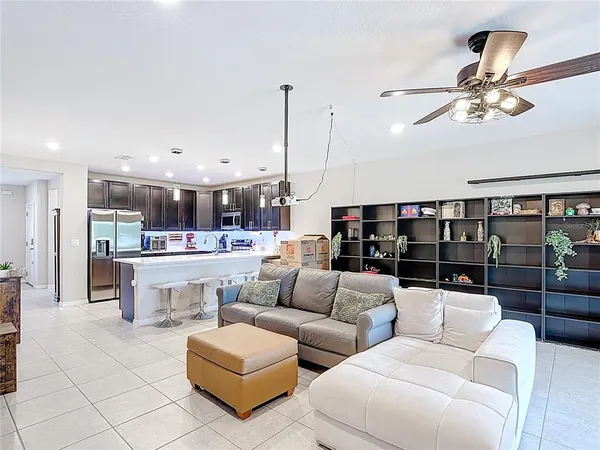 a living room with furniture and kitchen view