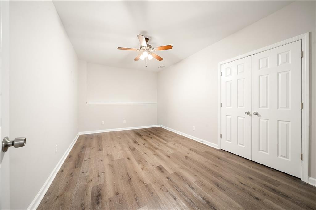 921 Pace Road Hiram, GA 30141 - Photo 36 of 41 an empty room with wooden floor fan and windows