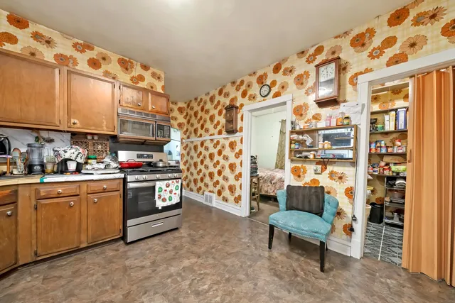 a kitchen with stainless steel appliances granite countertop a stove and a refrigerator