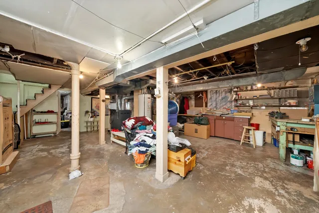 a view of a backyard with a table and chairs and potted plants