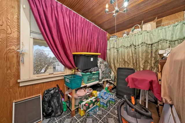 a view of a house with a big yard potted plants and large tree