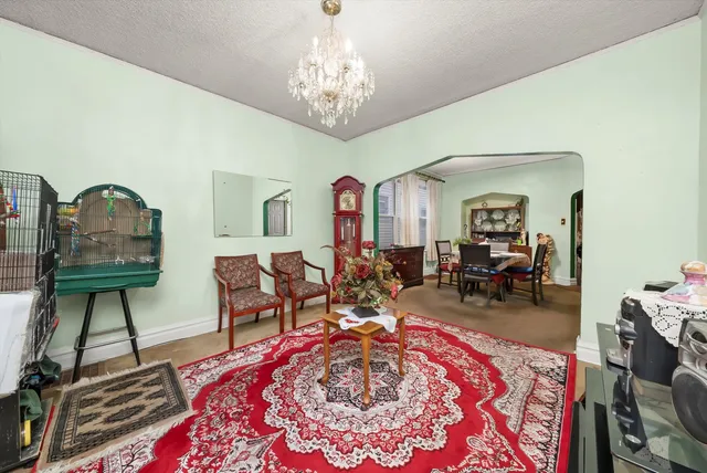 a living room with furniture and a chandelier