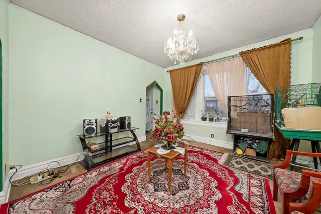 a bed room with furniture and a chandelier
