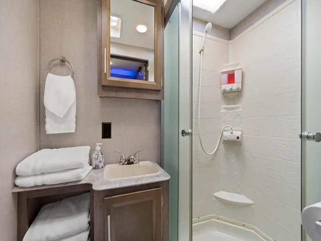 a bathroom with a sink toilet and shower