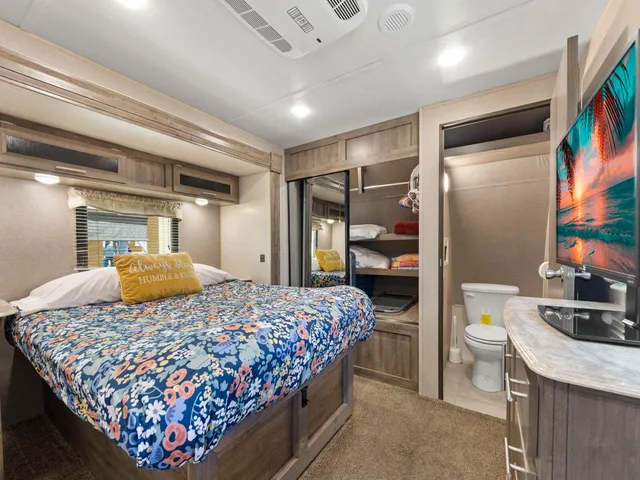 a bedroom with a bed and a mirror