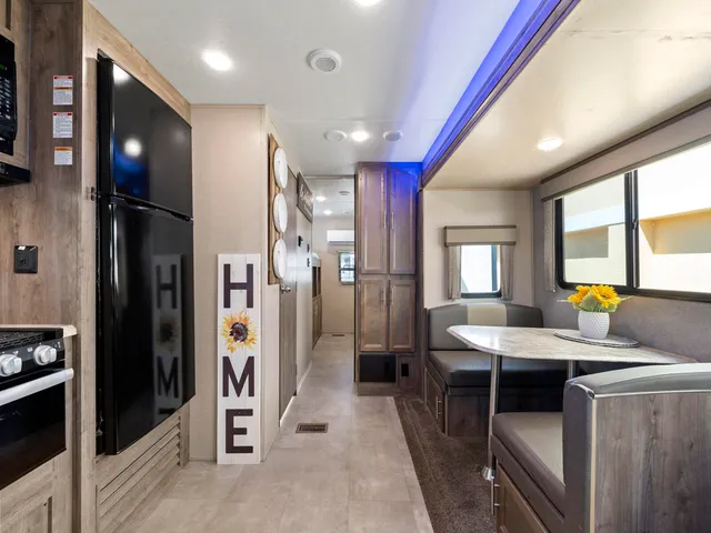 a kitchen with stainless steel appliances kitchen island granite countertop a refrigerator and a sink