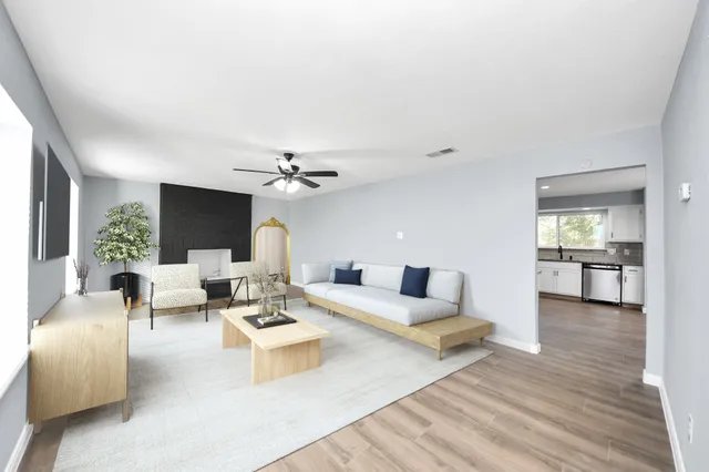 a living room with furniture and a wooden floor