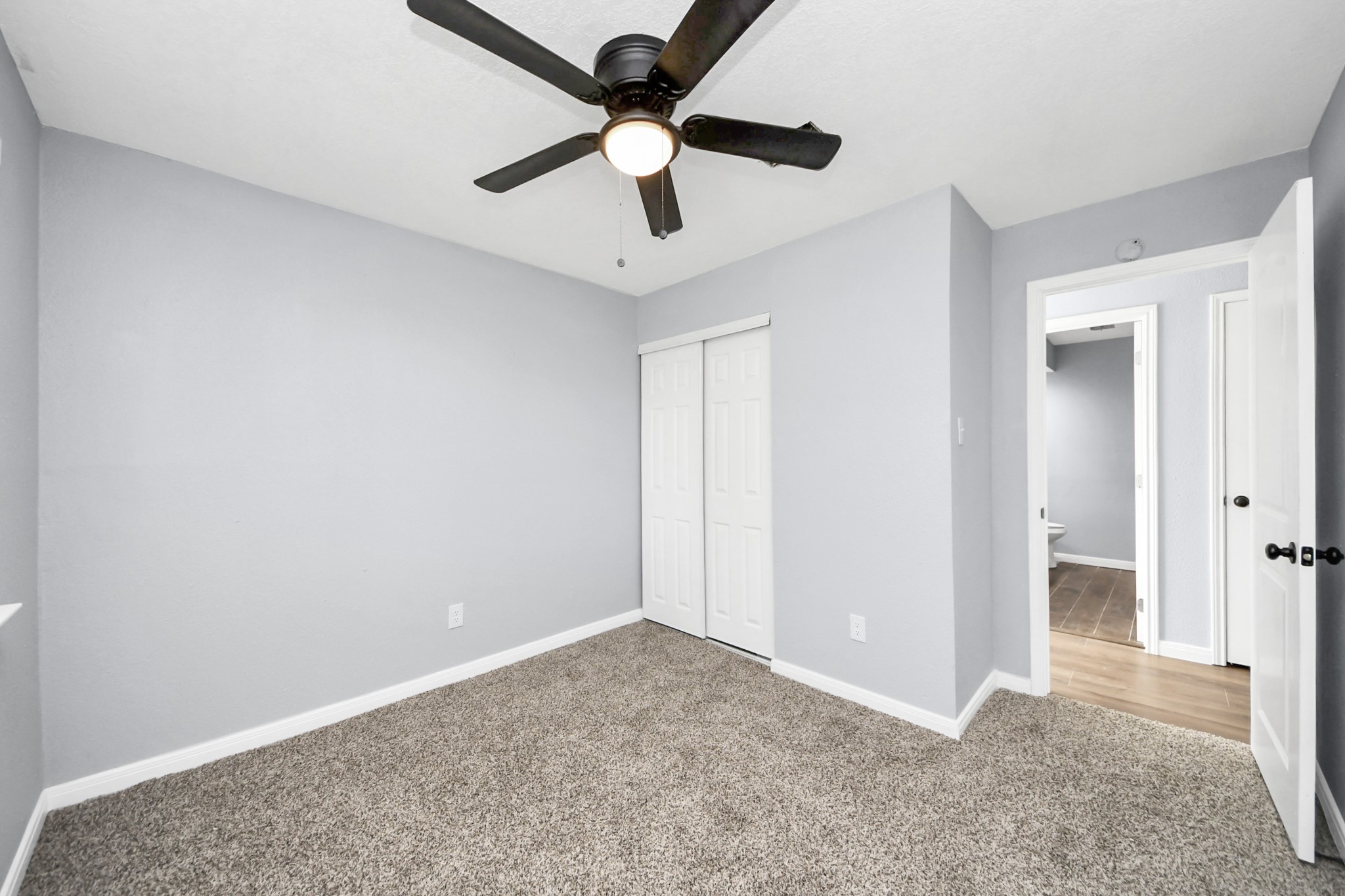 1806 Lacewing Lane Houston, TX 77067 - Photo 28 of 49 an empty room with a ceiling fan and carpet