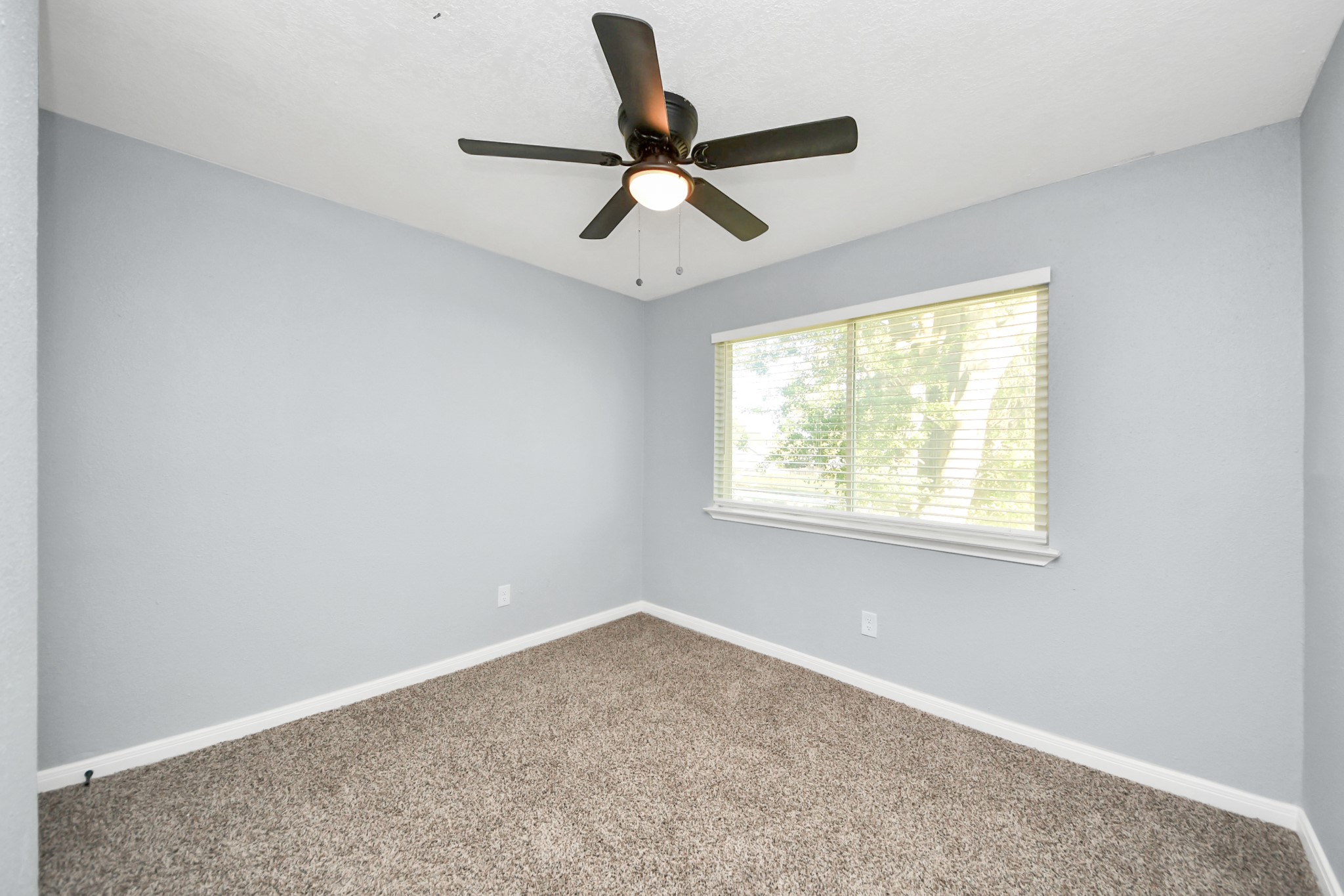 1806 Lacewing Lane Houston, TX 77067 - Photo 29 of 49 a view of a big room with windows and ceiling fan