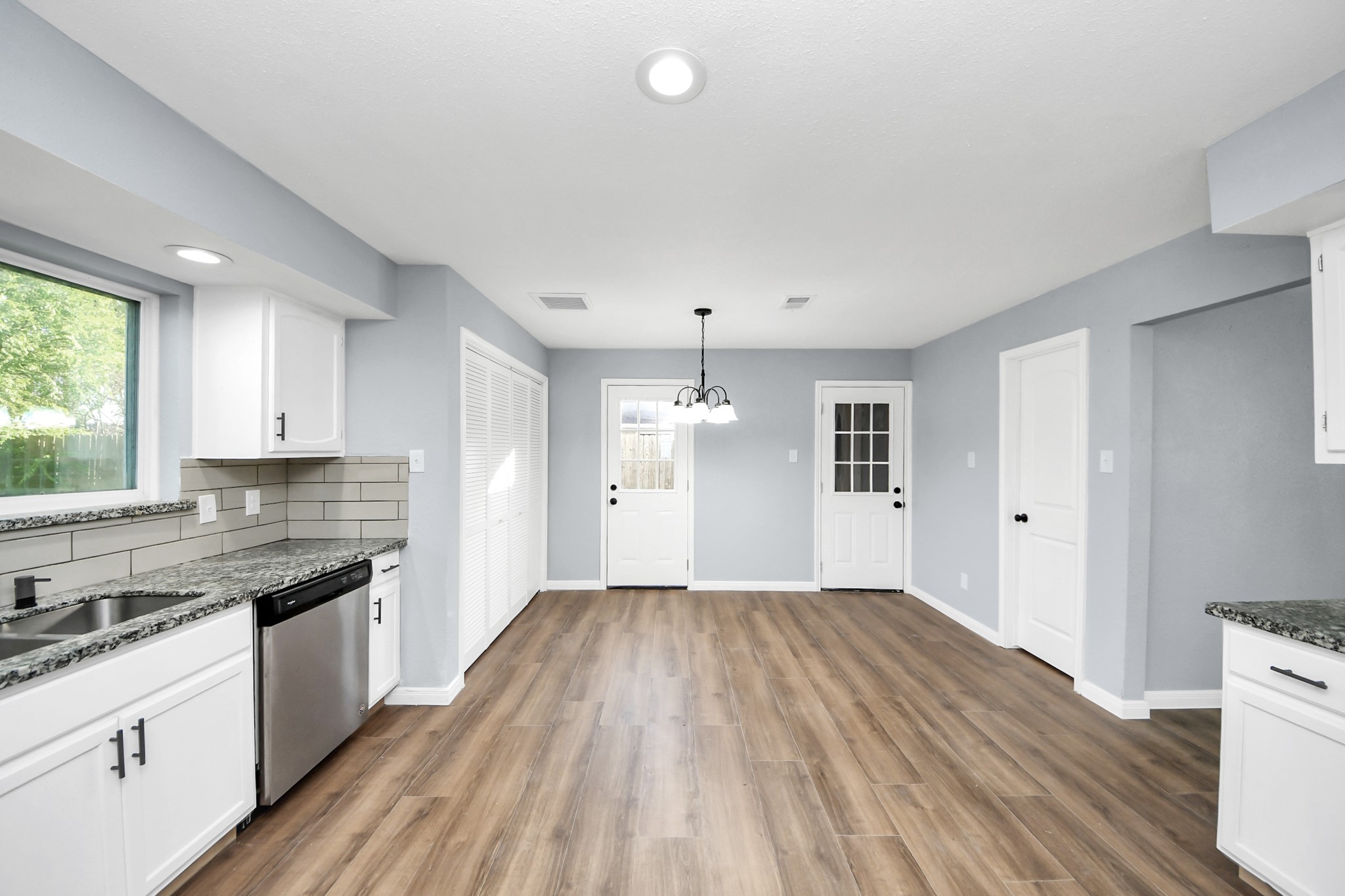 1806 Lacewing Lane Houston, TX 77067 - Photo 3 of 49 a kitchen with wooden floors and white cabinets