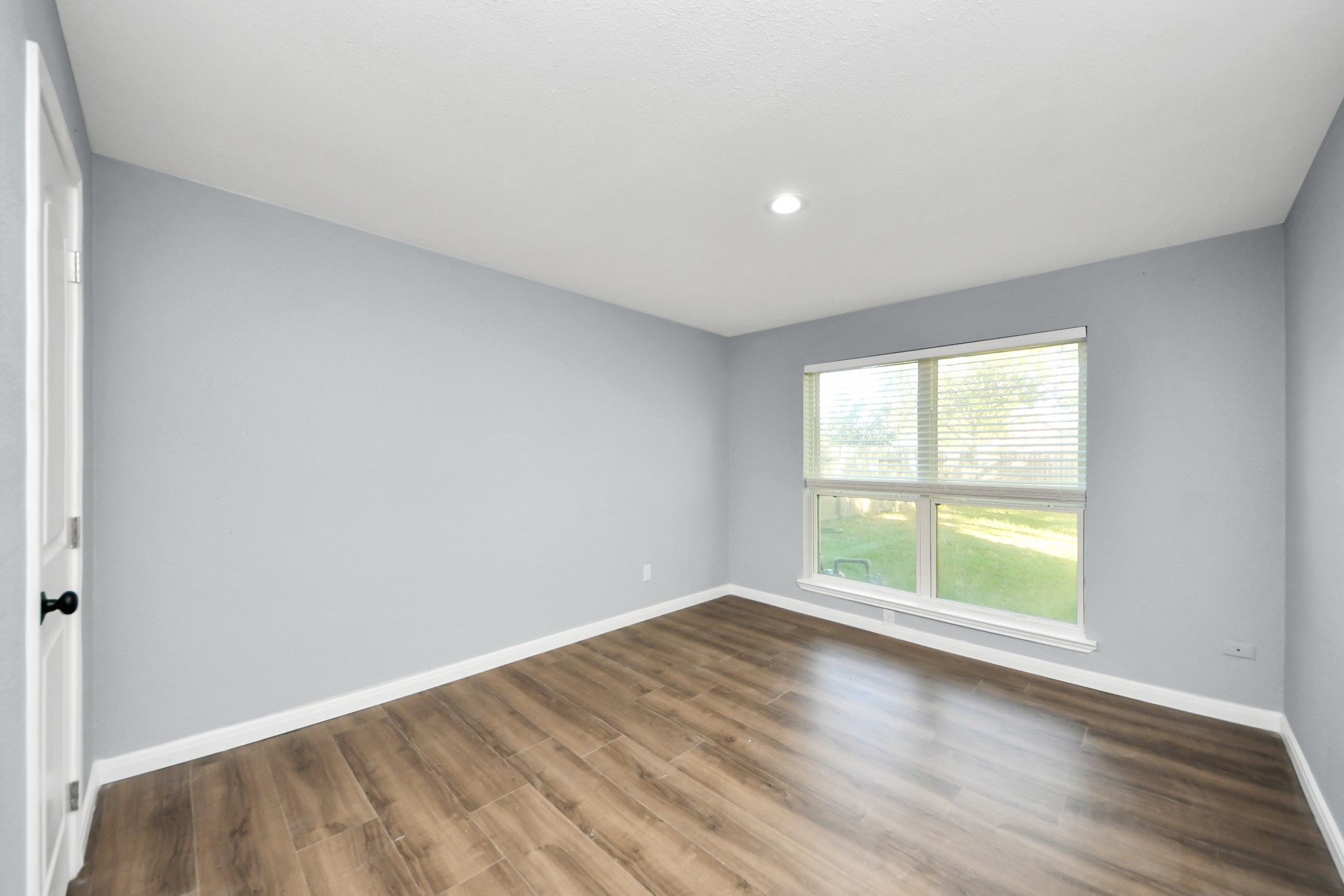 1806 Lacewing Lane Houston, TX 77067 - Photo 33 of 49 an empty room with wooden floor and windows