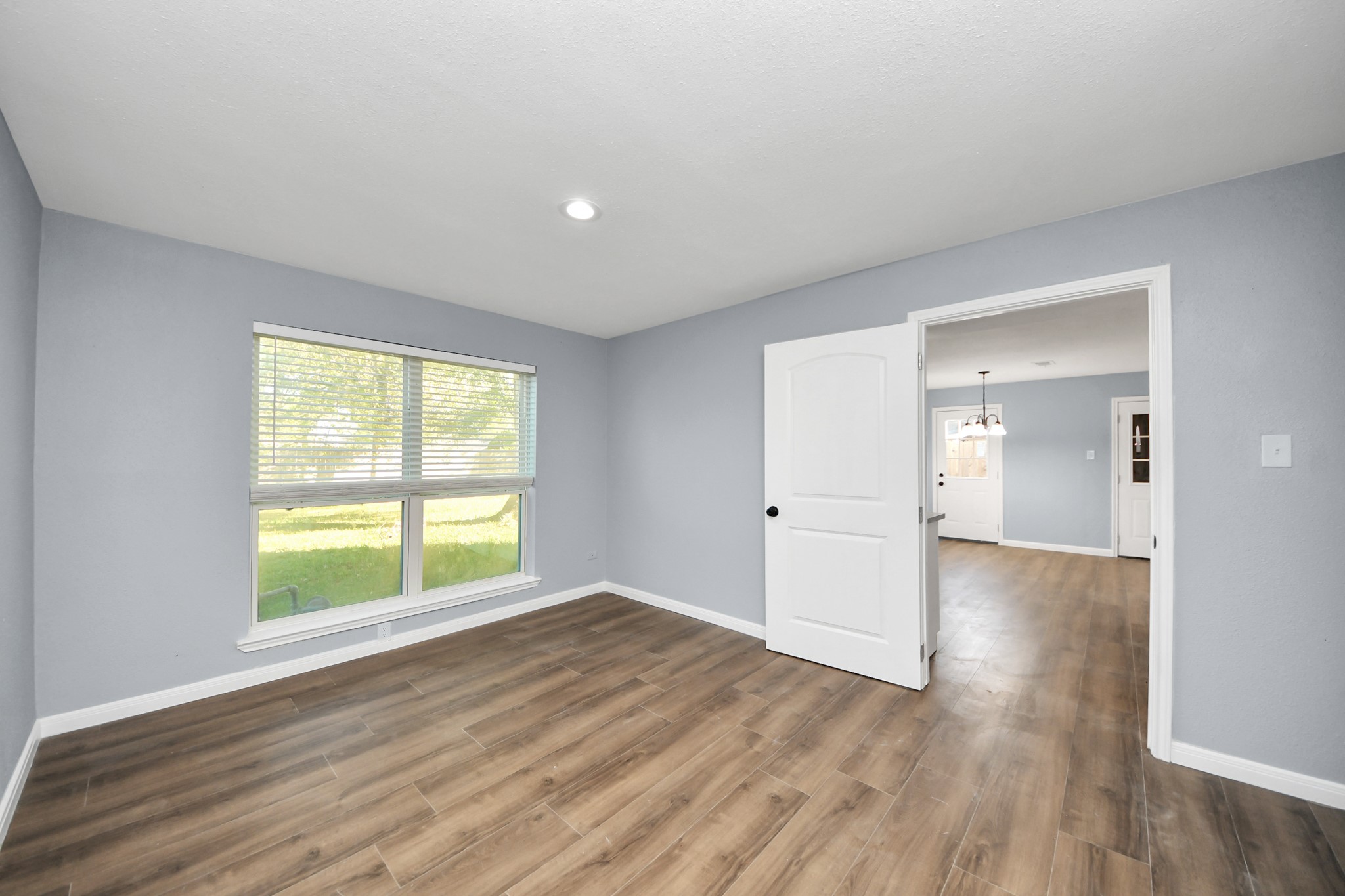 1806 Lacewing Lane Houston, TX 77067 - Photo 35 of 49 a view of an empty room with wooden floor and a window