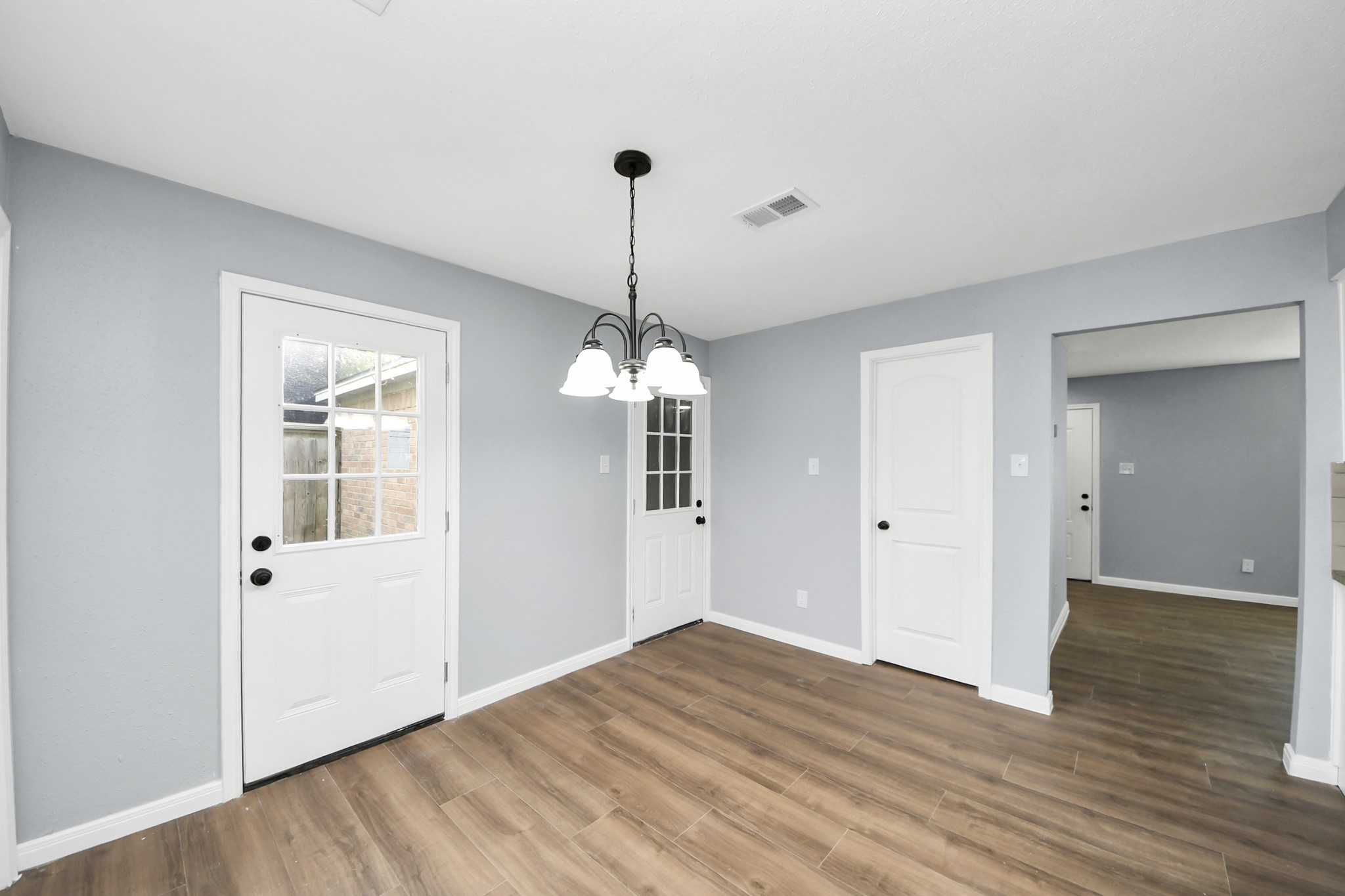 1806 Lacewing Lane Houston, TX 77067 - Photo 9 of 49 a view of a room with wooden floor chandelier and a window