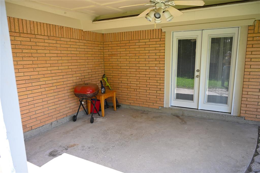 1352 Simpson Drive Hurst, TX 76053 - Photo 32 of 40 Covered patio featuring a concrete slab and full brick exterior walls