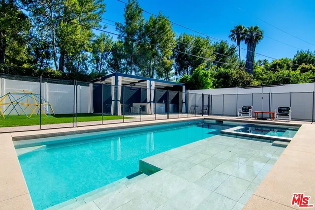 a view of swimming pool with chairs