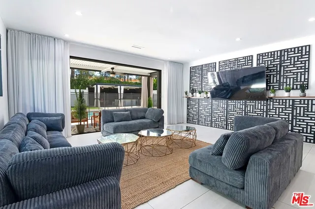 a kitchen with white cabinets and refrigerator