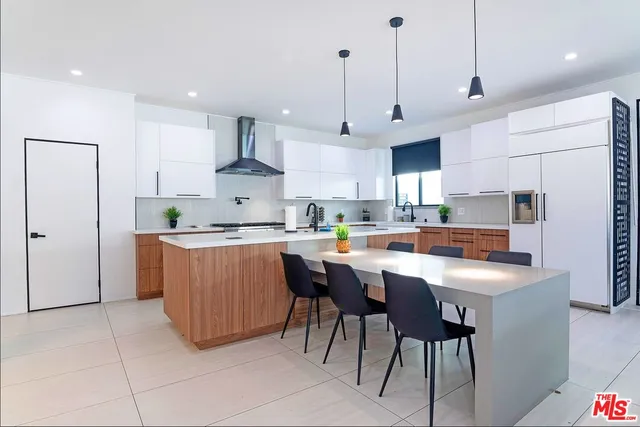 a kitchen with appliances a sink a counter top space and cabinets