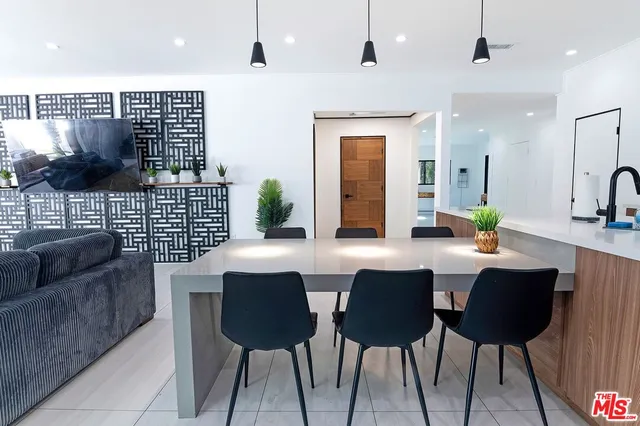 a kitchen with a sink a refrigerator and cabinets