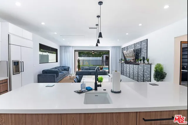 walk in closet with white cabinets