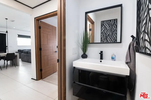 a bathroom with a double vanity sink a mirror and a