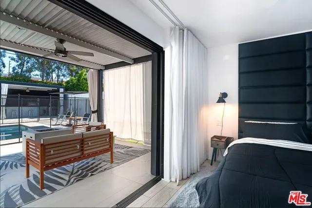 a bedroom with a bed and a potted plant