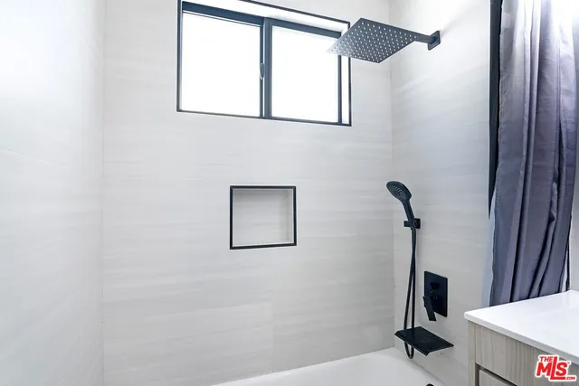 a living room with a furniture and a floor to ceiling window