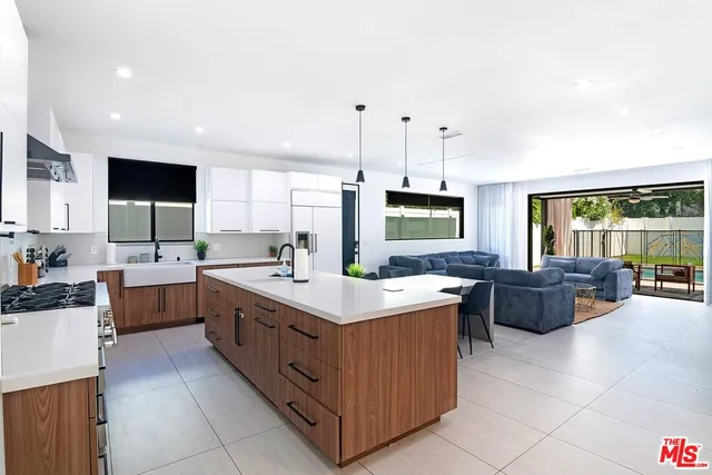 a front view of a house with a garden and yard