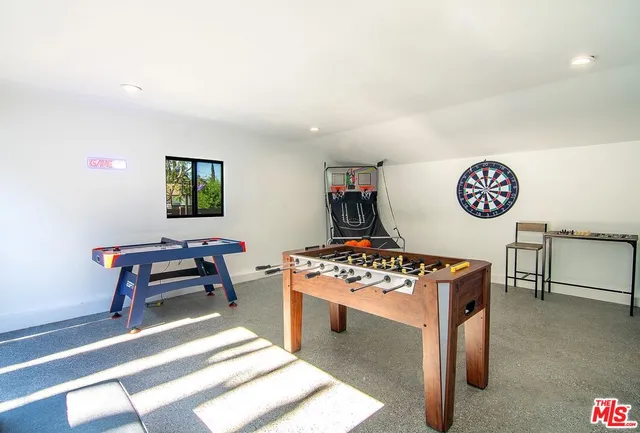 a view of a patio with table and chairs under an umbrella