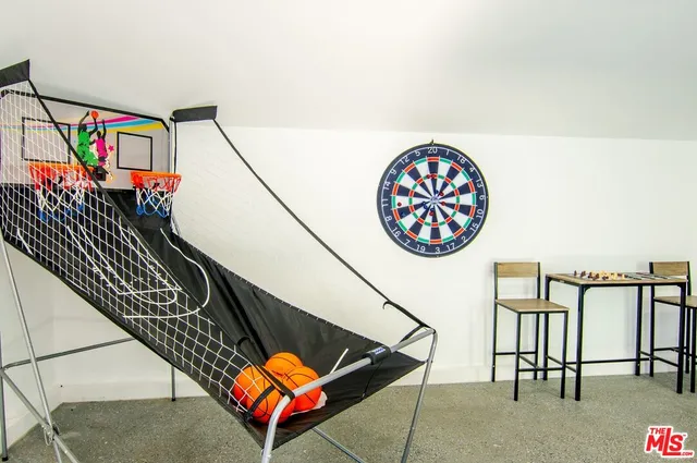a view of a backyard with a slide and wooden fence