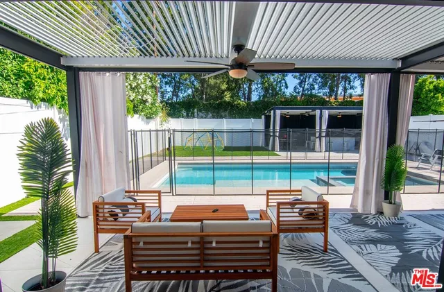 a kitchen with stainless steel appliances granite countertop a sink a stove and a refrigerator