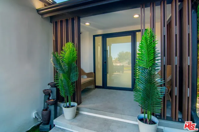 a view of a livingroom with furniture and an empty room