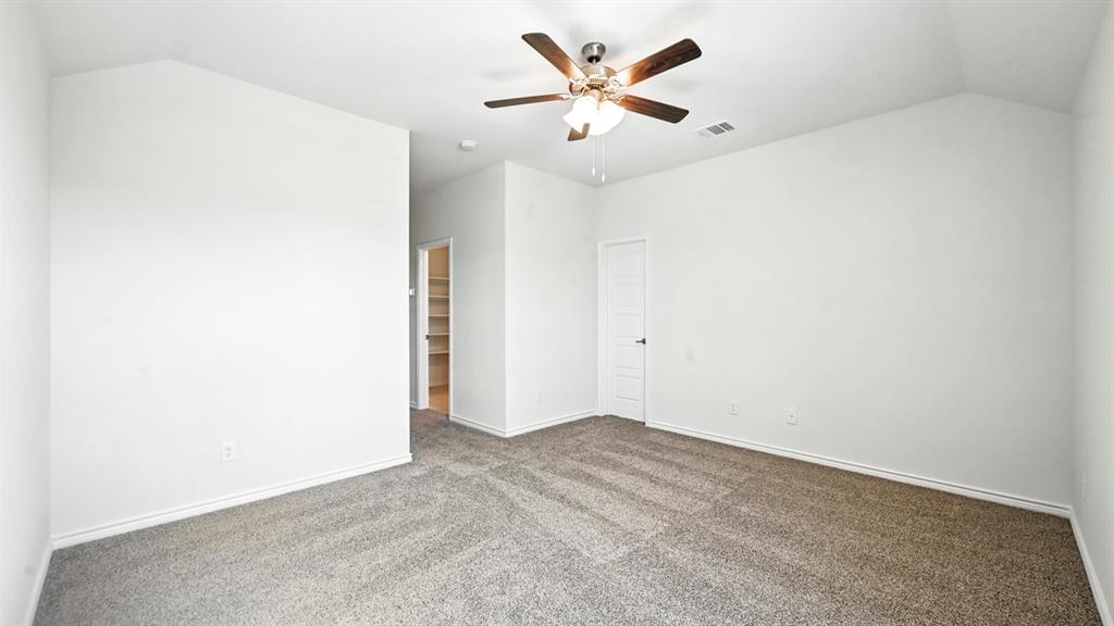 3413 Amaretto Road Aubrey, TX 76227 - Photo 13 of 34 an empty room with a ceiling fan and a window