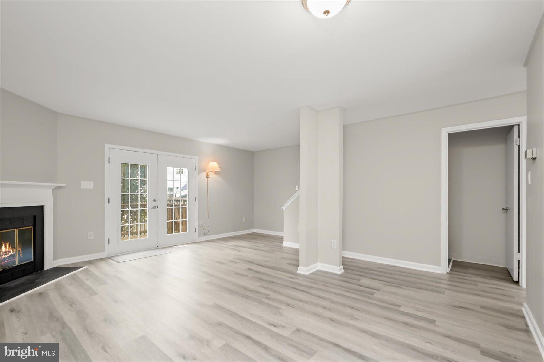 17 Offspring Court Perry Hall, MD 21128 - Photo 12 of 42 an empty room with wooden floor fireplace and windows