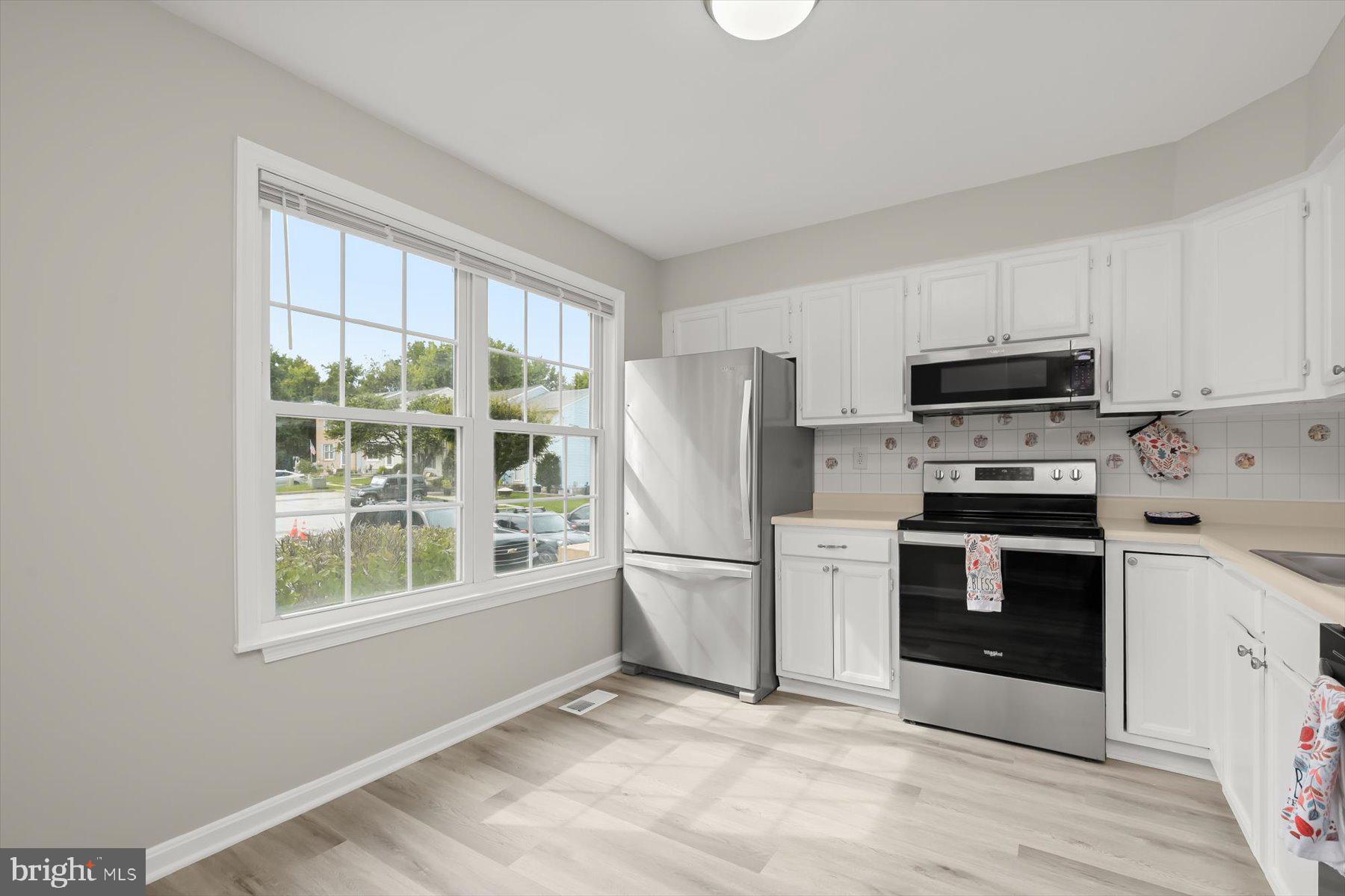 17 Offspring Court Perry Hall, MD 21128 - Photo 13 of 42 a kitchen with a stove a microwave and refrigerator