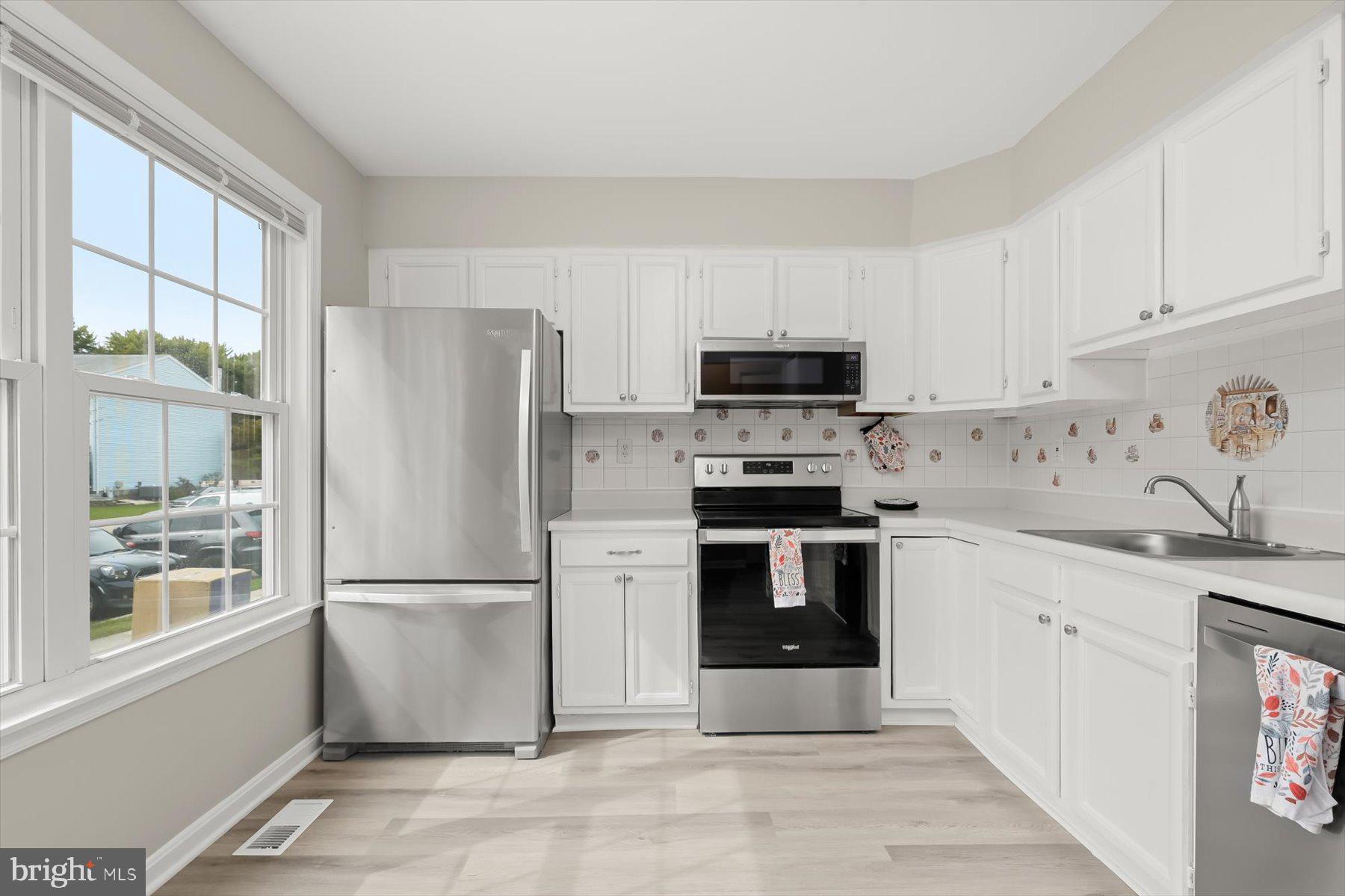 17 Offspring Court Perry Hall, MD 21128 - Photo 14 of 42 a kitchen with a refrigerator a stove a sink and a window