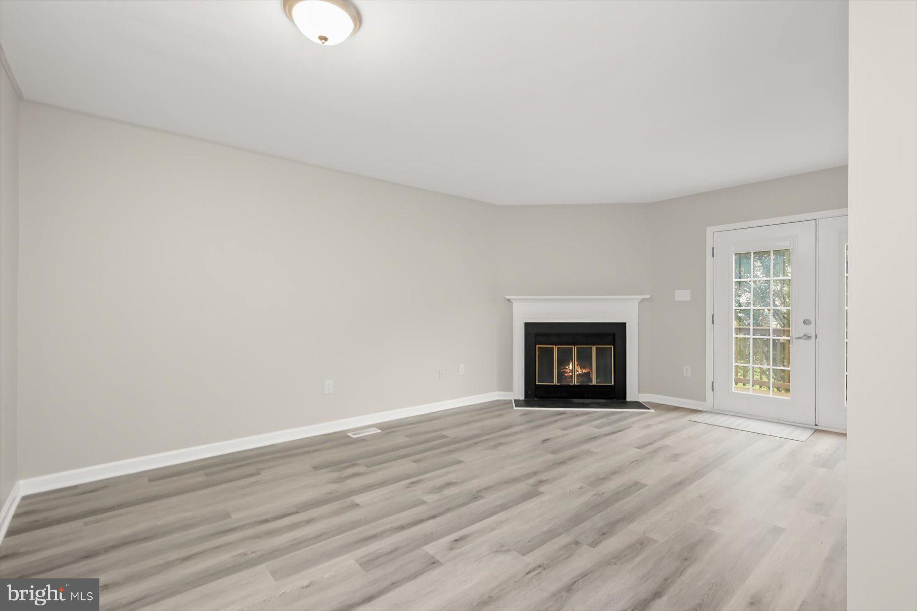 17 Offspring Court Perry Hall, MD 21128 - Photo 3 of 42 a view of an empty room with wooden floor and a window
